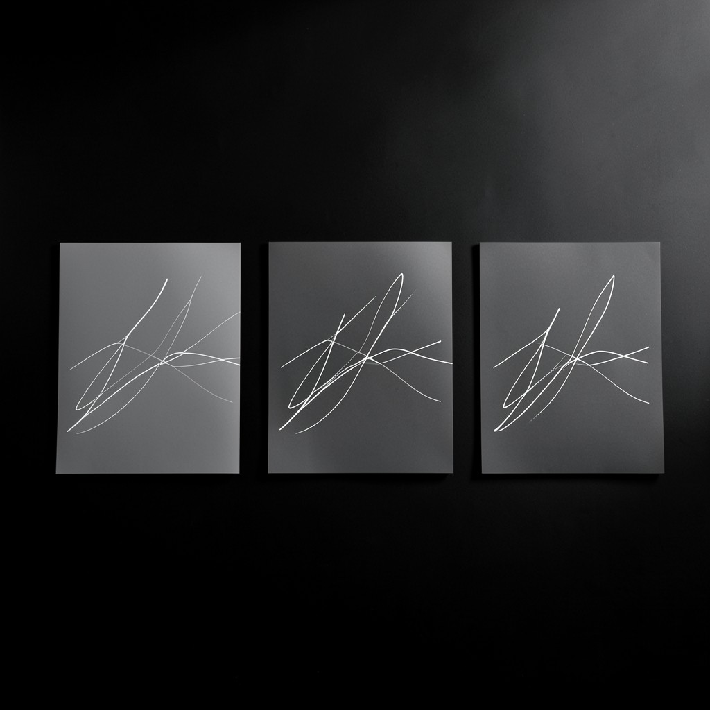 Minimal workforce chart printouts with clear titles on a dark surface